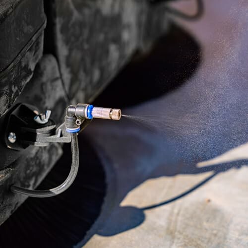 Water spray nozzle cleaning car underside.