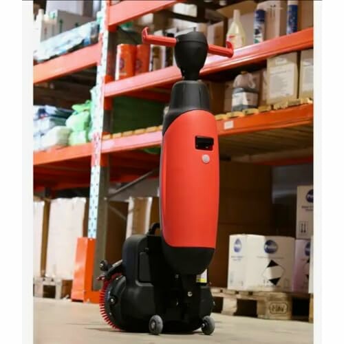 Compact floor cleaning machine in a warehouse