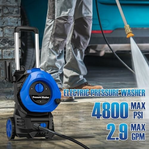 Person using electric pressure washer on pavement