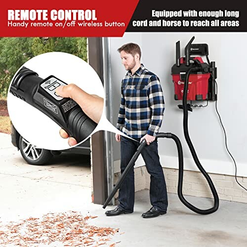 Man using a wall-mounted garage vacuum with remote control