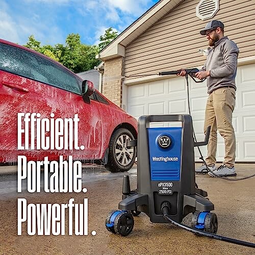 Man using a Westinghouse pressure washer on a car in a driveway.