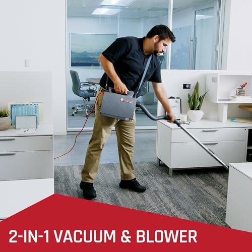 Person using a 2-in-1 vacuum and blower in an office.