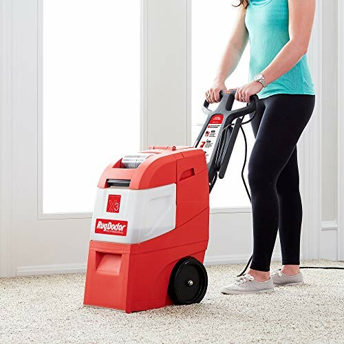 Person using Rug Doctor carpet cleaner on light carpet