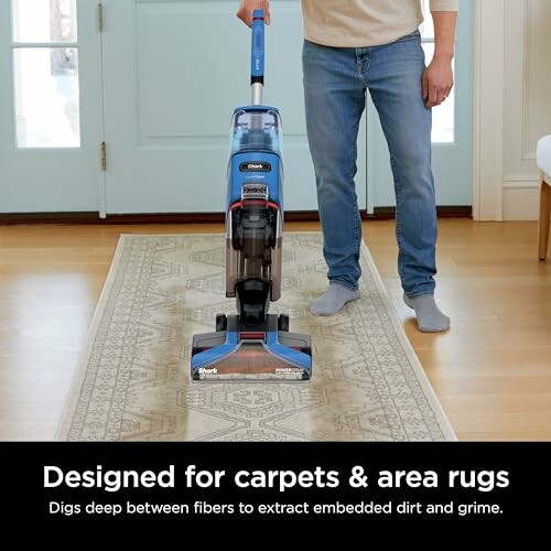 Person using vacuum cleaner on carpet, designed for deep cleaning.