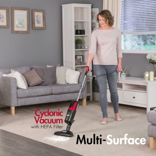 Woman using a cyclonic vacuum with HEPA filter on carpet